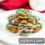 caramel pretzel bites drizzled with green, red, and white chocolate and topped with holiday sprinkles