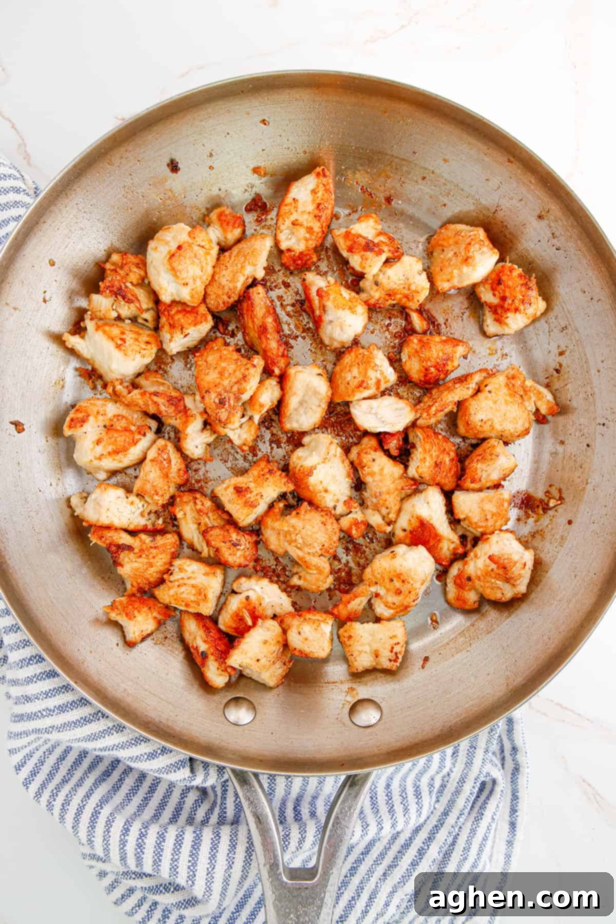 golden brown cooked pieces of bite-sized chicken pieces in a skillet