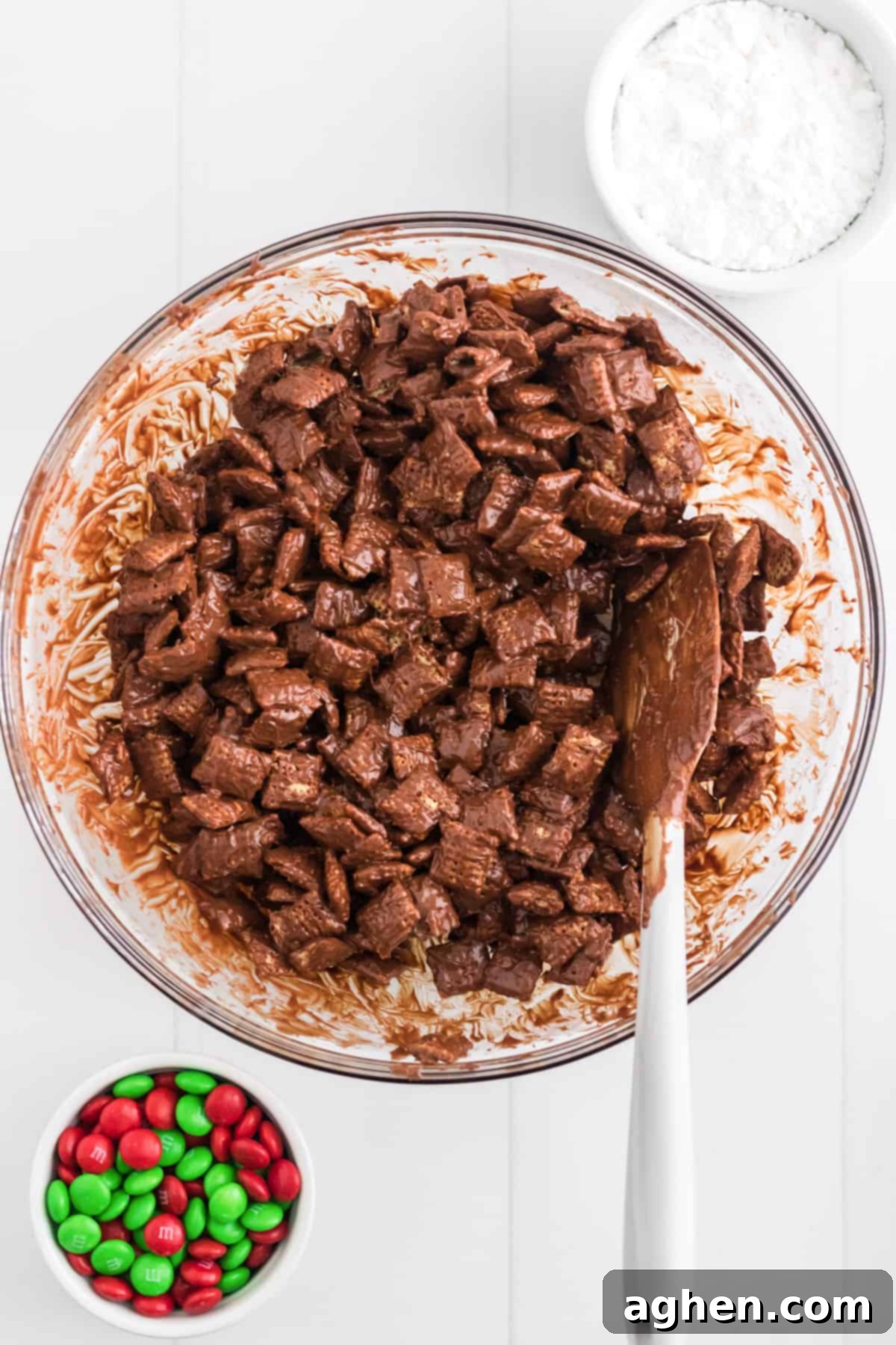 large glass bowl filled with chocolate and peanut butter coated chex cereal