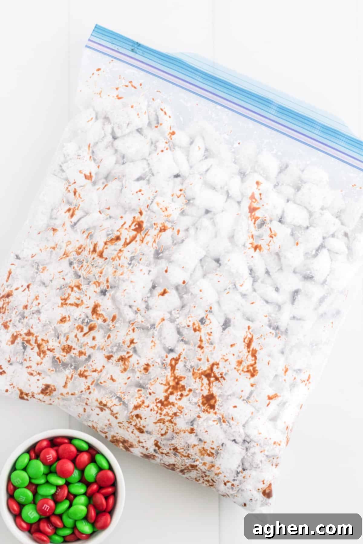 Gallon-size ziplock bag with muddy buddies inside. Bowl of red and green M&Ms are next to it.