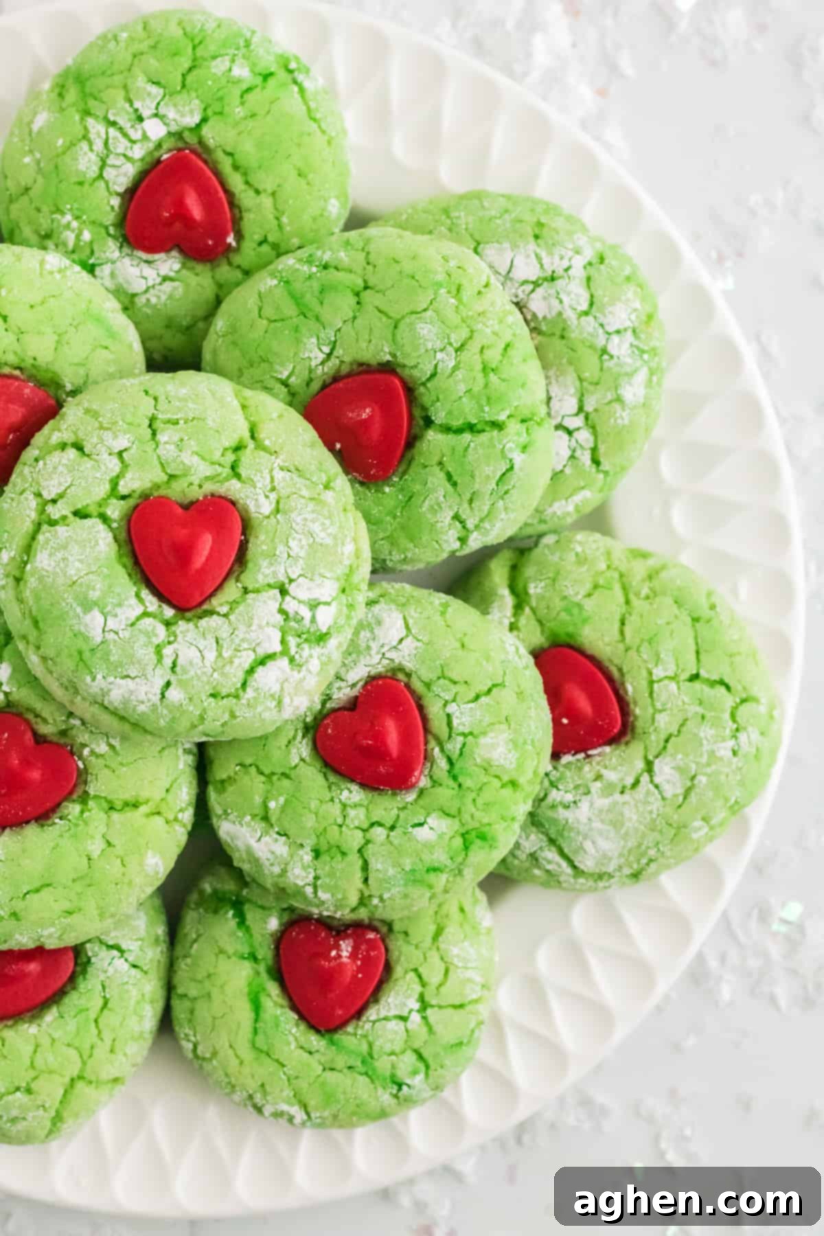 Festive Grinch Cookies 4 Grinch Heart Cookies on white plate