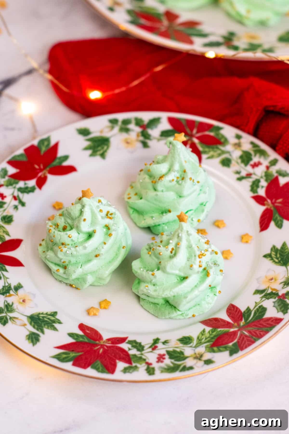 Meringue Christmas Tree Cookies on poinsettia plates.