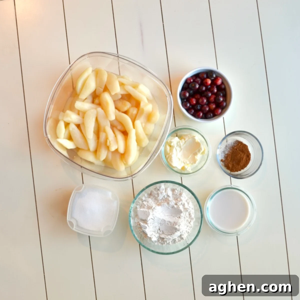 Weight Watchers Slow Cooked Cranberry Pear Cobbler 3 Various ingredients laid out for making the cobbler, including canned pears, cranberries, flour, and sweetener