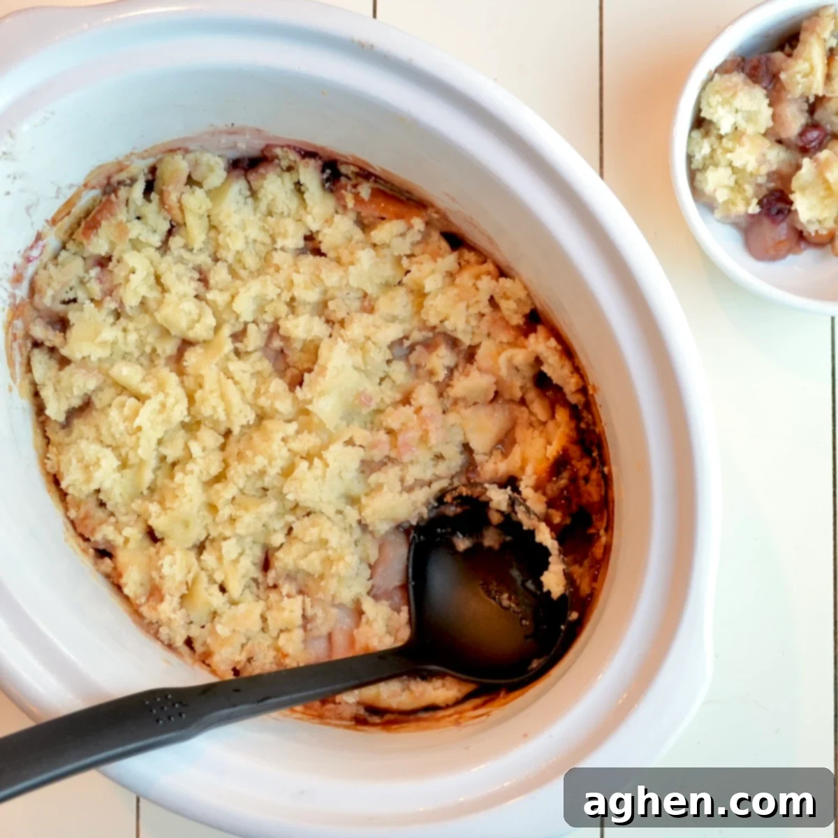 Weight Watchers Slow Cooked Cranberry Pear Cobbler 5 The delicious cranberry pear cobbler cooking inside a slow cooker