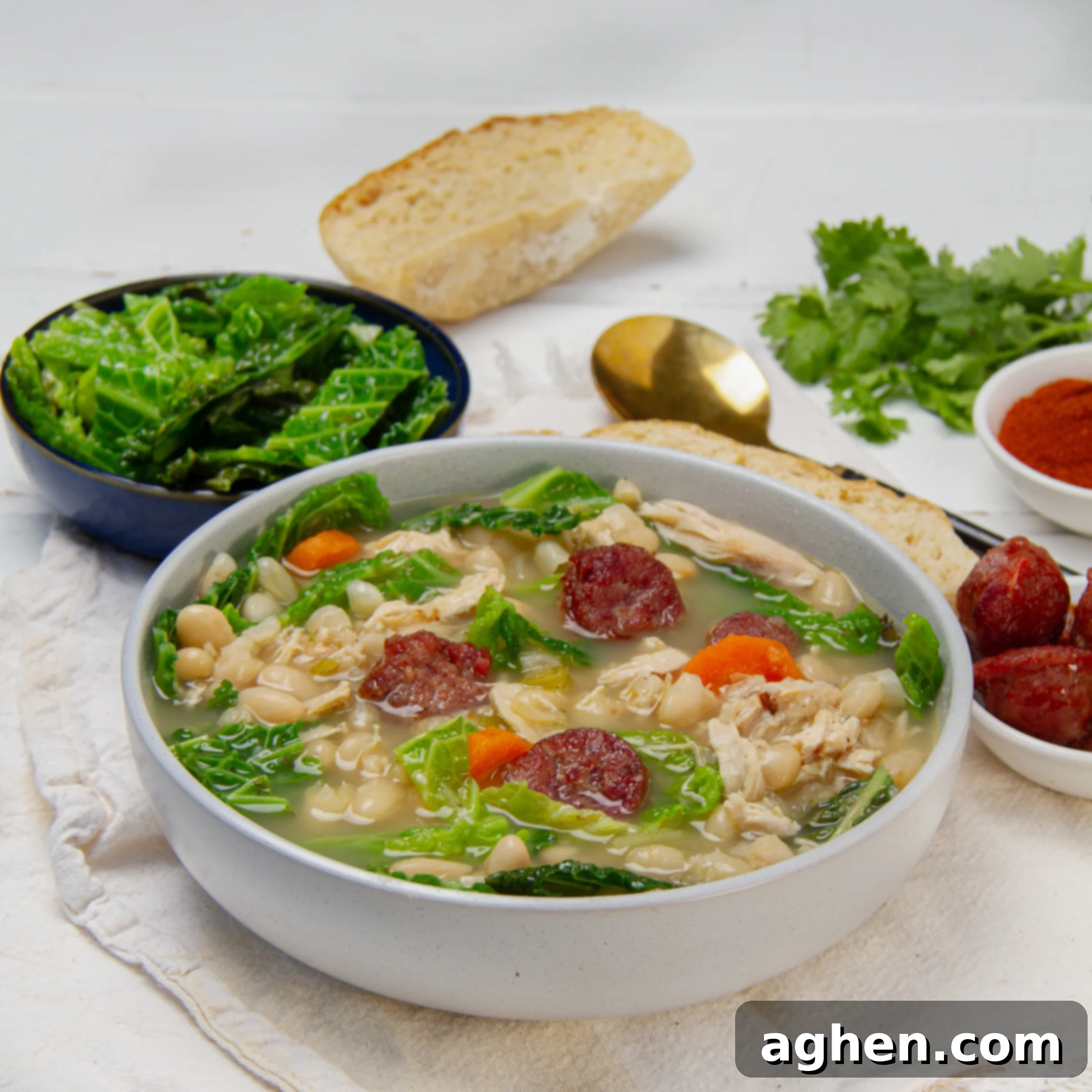 Hearty Portuguese Kale Soup 2 Thick and hearty Portuguese Kale Soup with white beans in a bowl, garnished with a drizzle of olive oil.