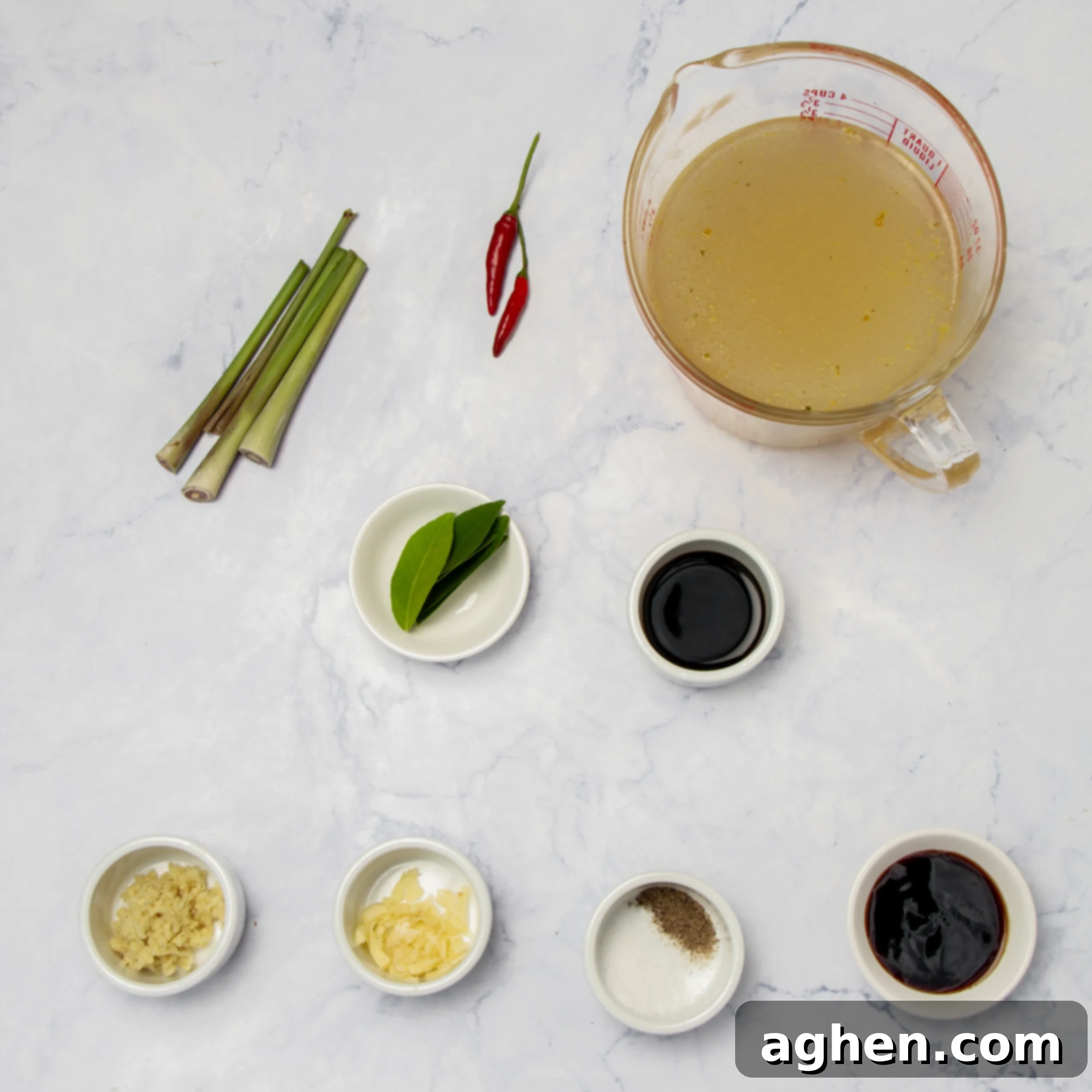 Tom Yum Soup 3 Tom Yum Soup broth ingredients laid out in separate dishes, showing lemongrass, galangal, kaffir lime leaves, and chilies.
