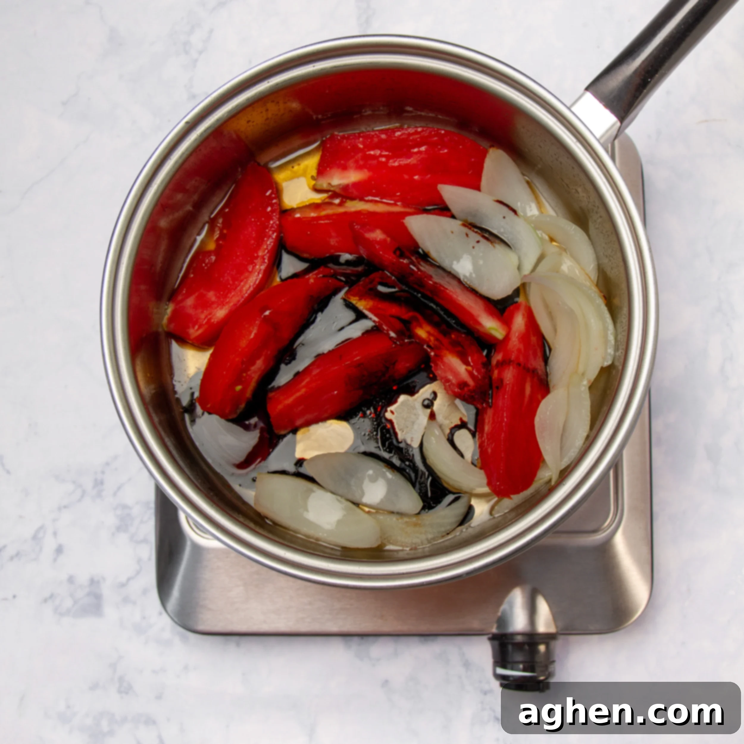 Tom Yum Soup 7 The rich Tom Yum soup broth combined with sautéed vegetables, simmering gently in a pot.