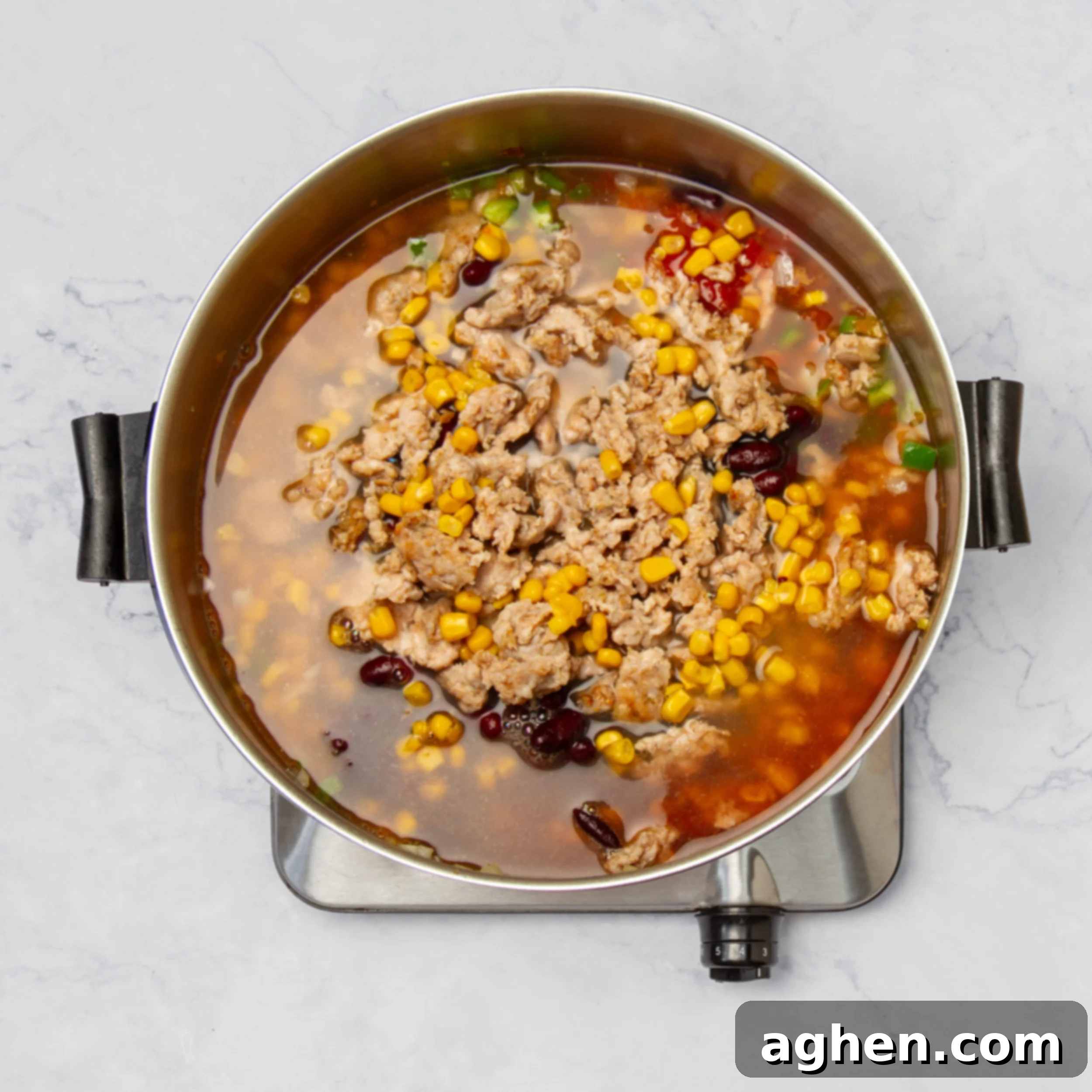 Weight Watchers Turkey Taco Soup: A Fall Favorite 7 All the turkey taco soup ingredients simmering together in a large pot, covered.