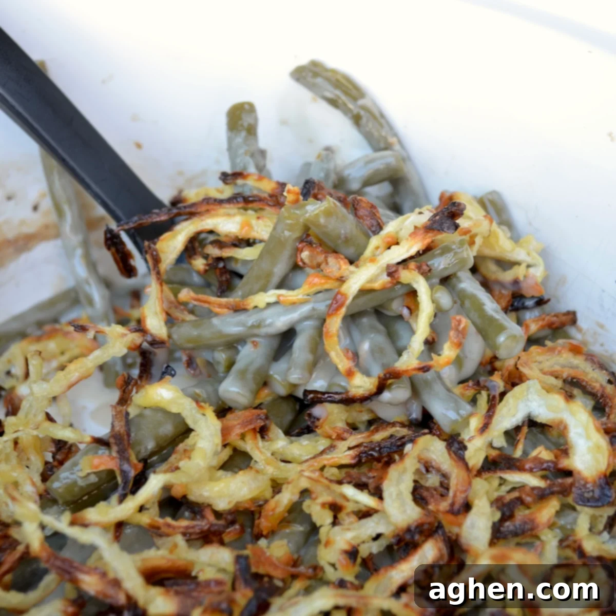 Classic green bean casserole with a generous layer of golden crispy onions on top, ready to be served.