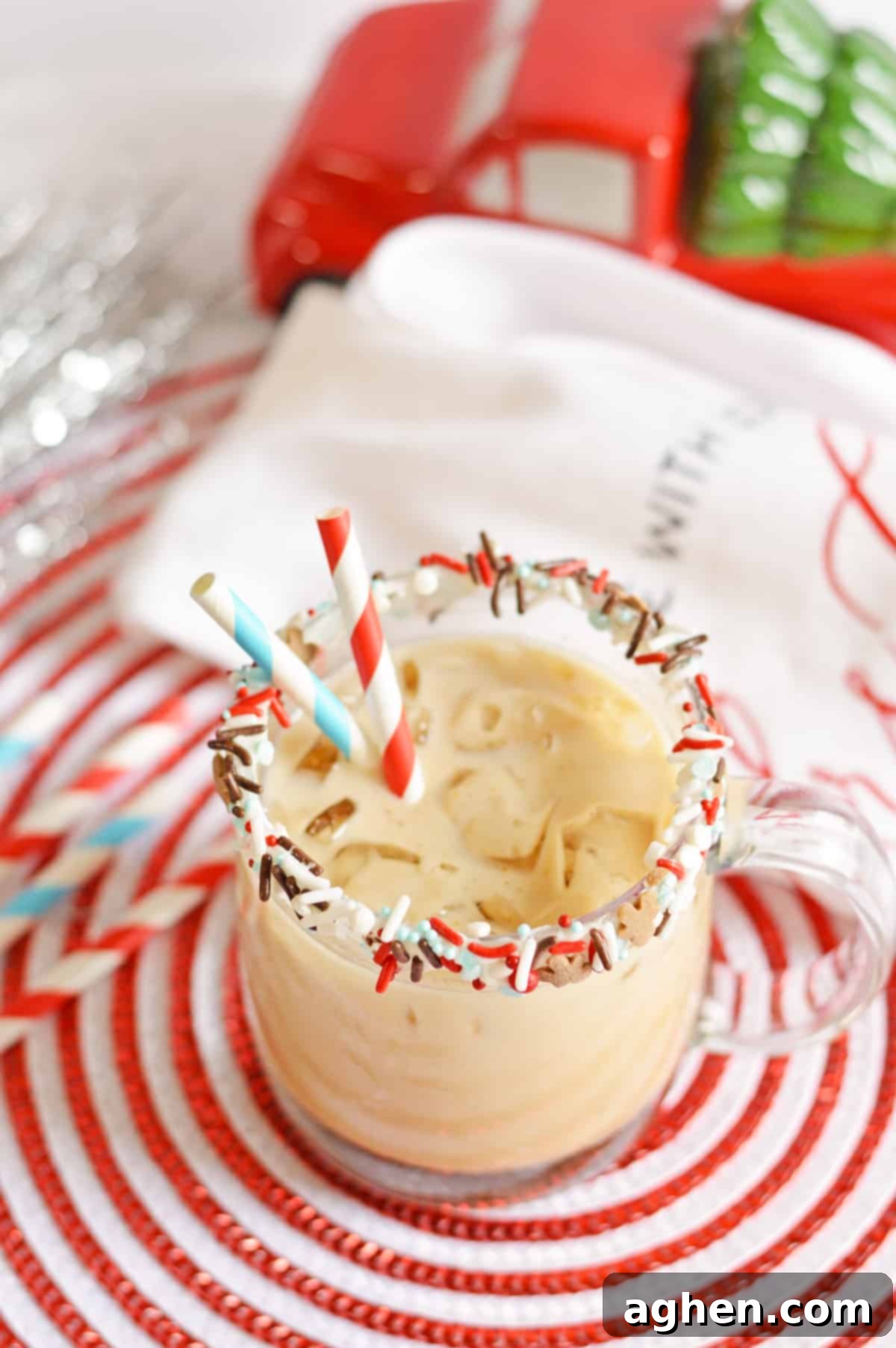 Gingerbread Cookie Cocktail in a glass mug rimmed with vanilla frosting and sprinkles.
