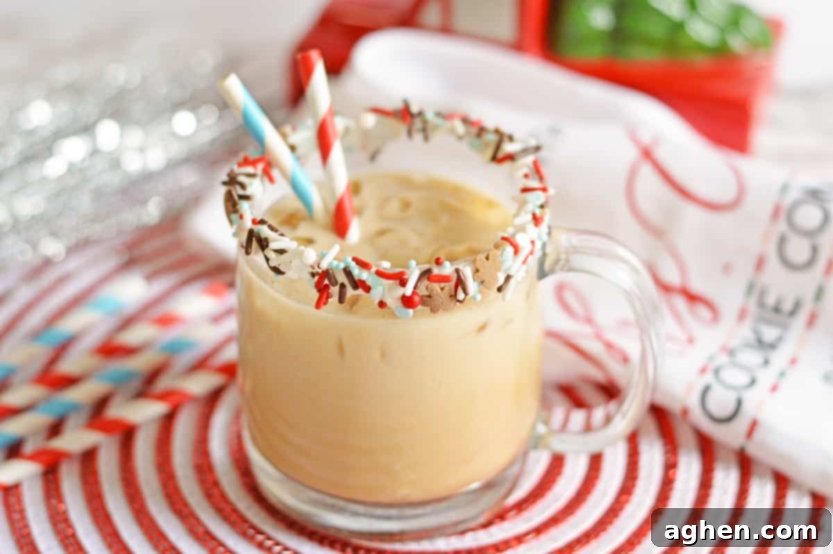 Gingerbread vodka cocktail in sprinkle-rimmed glass mug with paper straws and festive holiday decor in the background