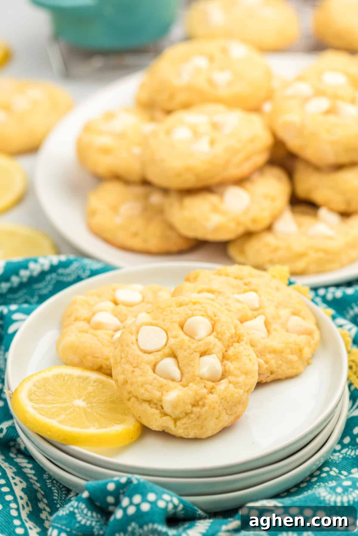 Close-up of a single lemon cookie on a plate with a lemon slice, highlighting its perfect texture and color.