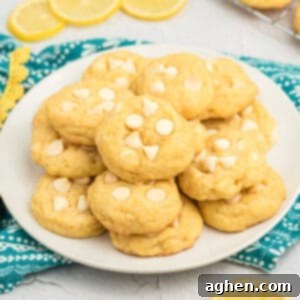 Lemon pudding cookies with white chocolate chips on plate.