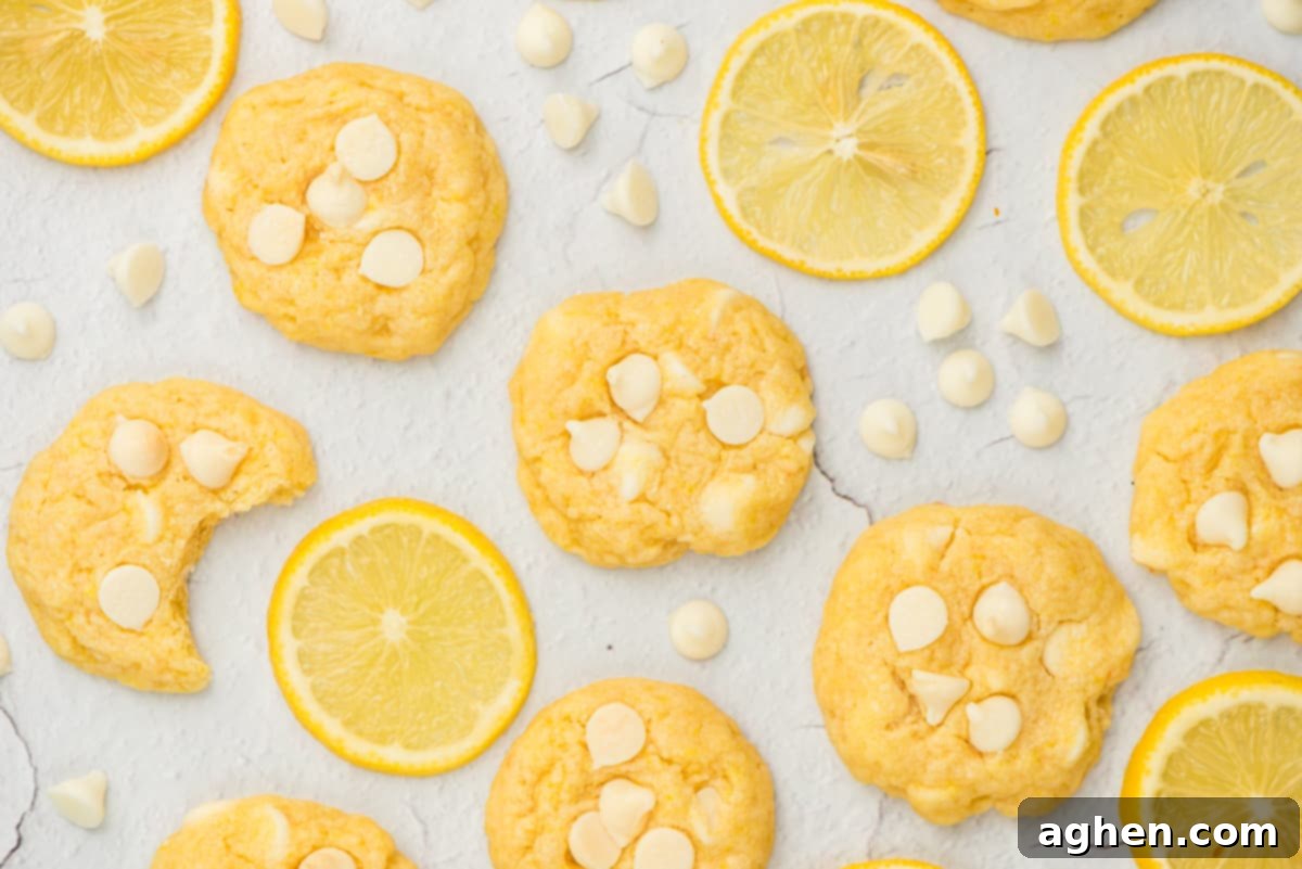Platter of soft lemon cookies with white chocolate chips, garnished with fresh lemon slices.