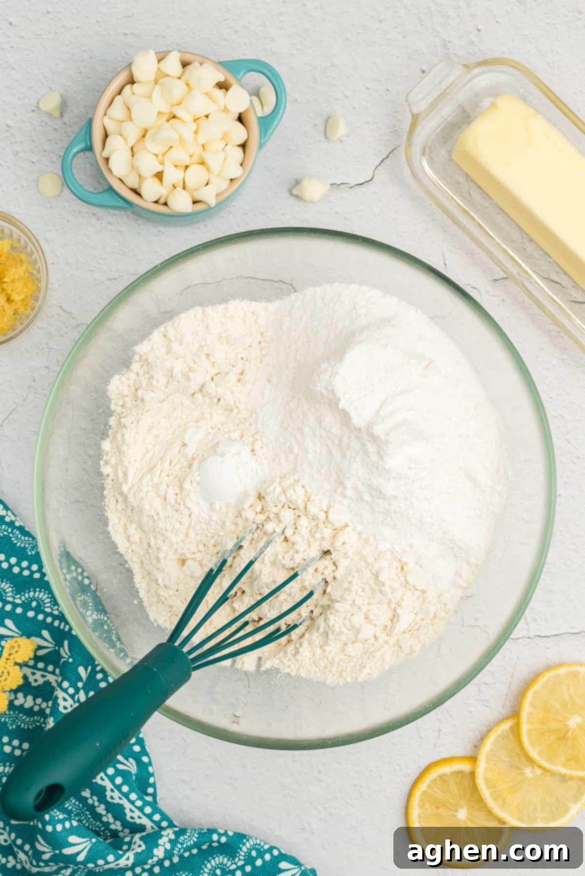 Dry ingredients for lemon pudding cookies – flour, baking powder, and lemon pudding mix – whisked together in a bowl.