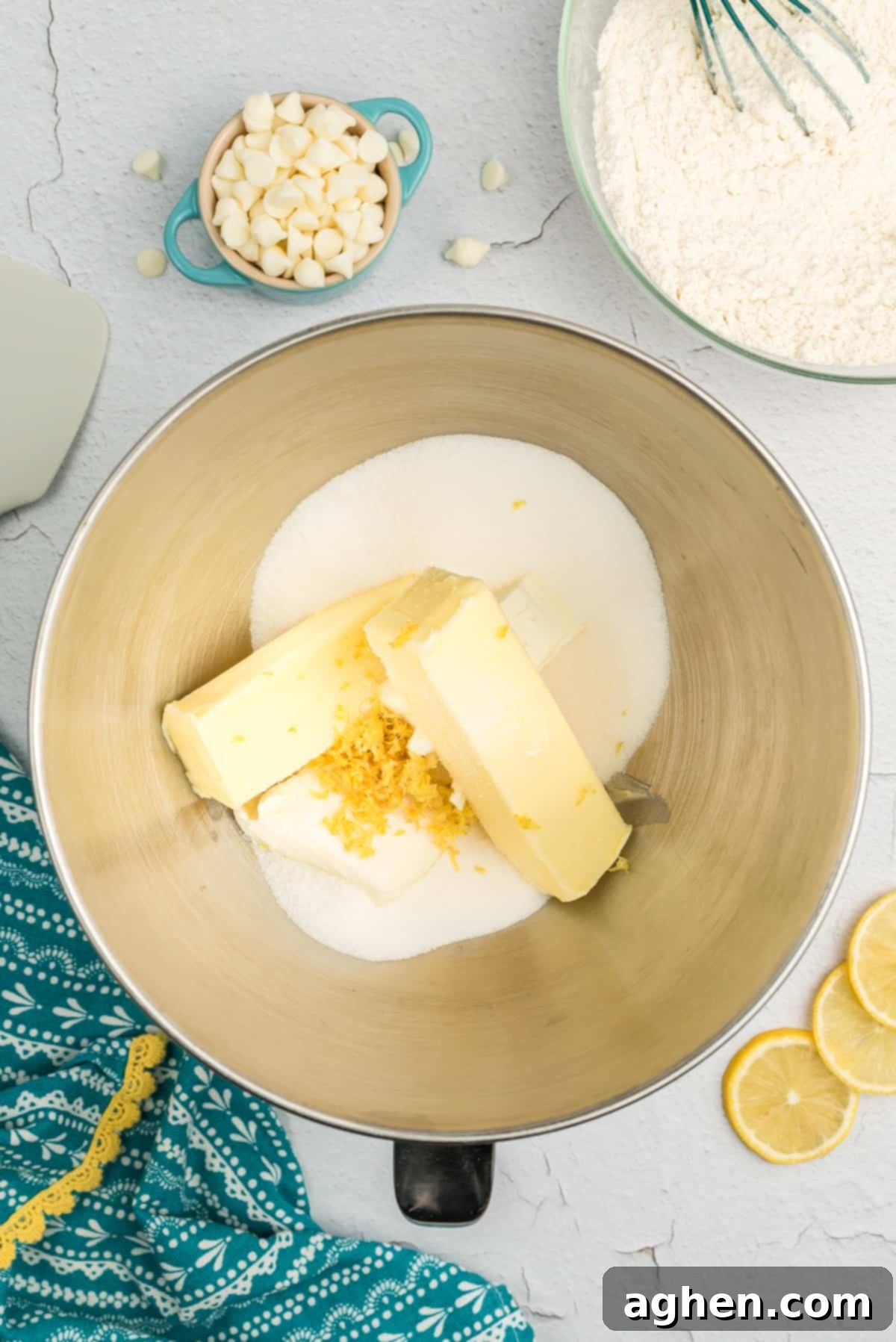 Creamed butter, sugar, and softened cream cheese in the bowl of a stand mixer, ready for the next step.