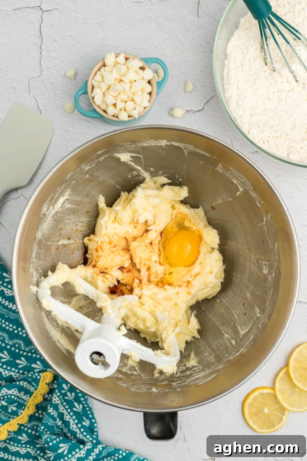 Egg, vanilla, and lemon zest added to the creamed butter, cream cheese, and sugar mixture in a stand mixer.
