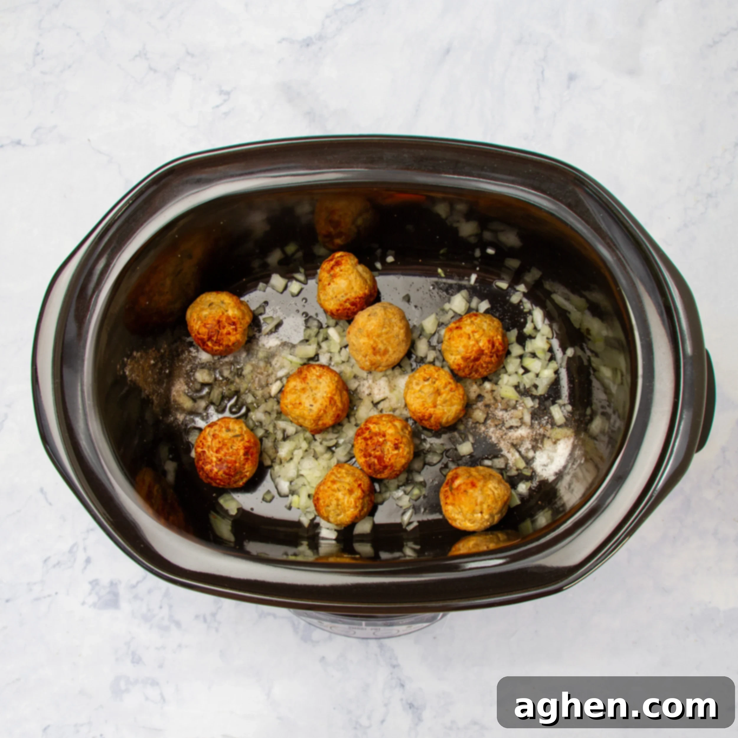 Meatballs cooking with onion. 