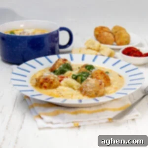 Savory and comforting slow cooker Tuscan meatballs with gnocchi on a plate.