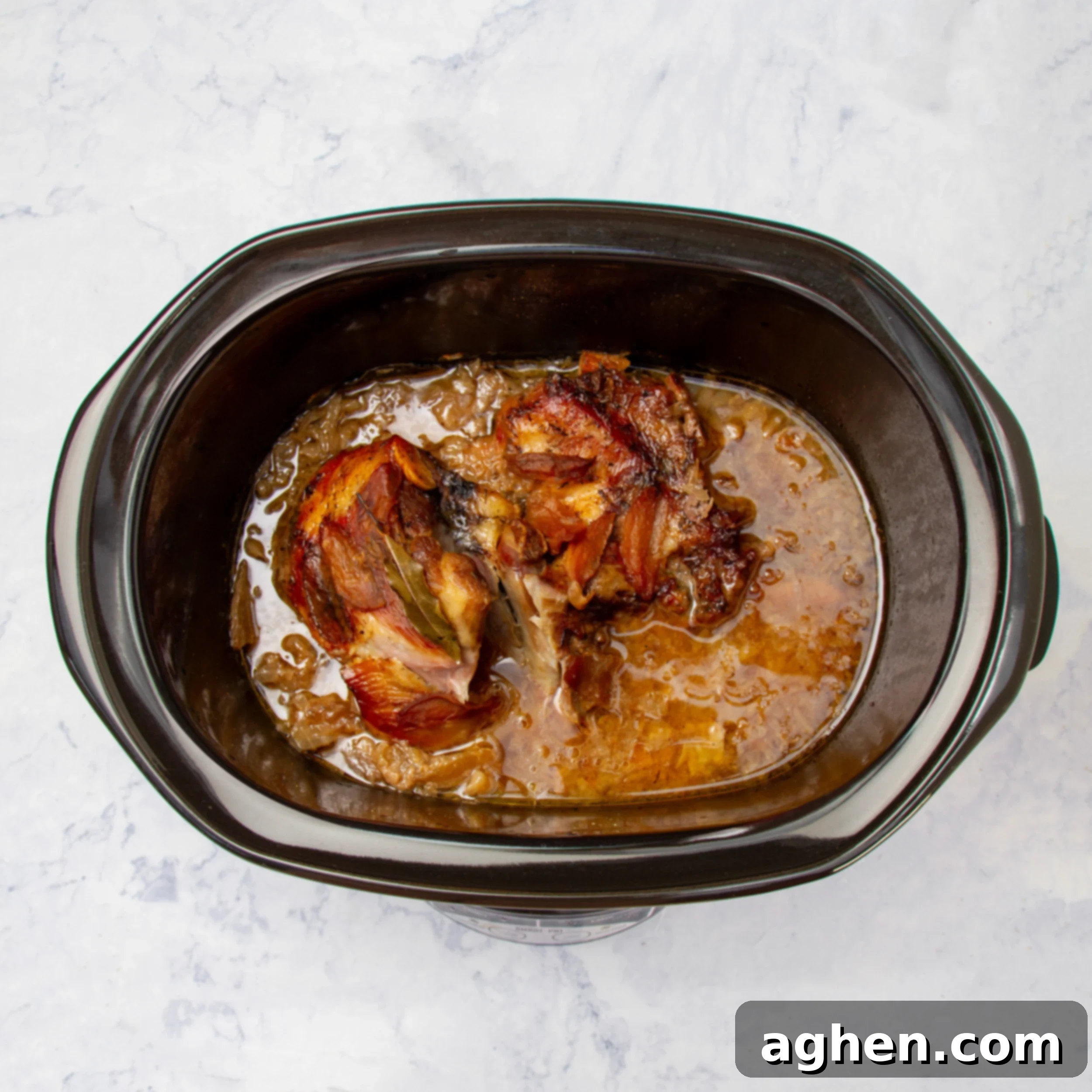 Cooked pork and sauerkraut in the slow cooker. 