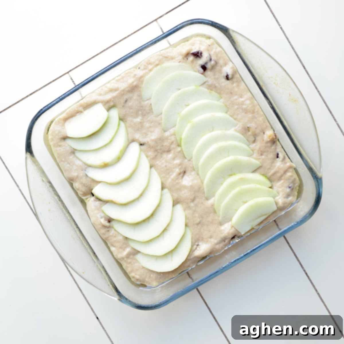 Guilt-Free Thanksgiving Cake 5 Unbaked cake batter with apple slices arranged on top, ready for the oven.