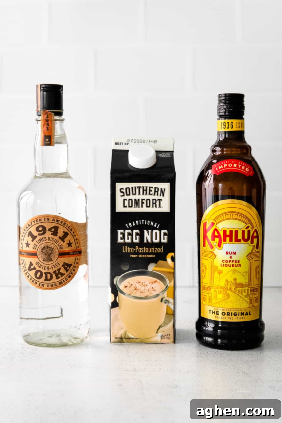 Bottles of 1941 Vodka and Kahlua coffee liqueur, alongside a carton of creamy eggnog, the essential ingredients for an Eggnog White Russian.