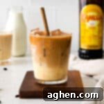 A festive Eggnog White Russian cocktail in a glass, ready for holiday celebrations.