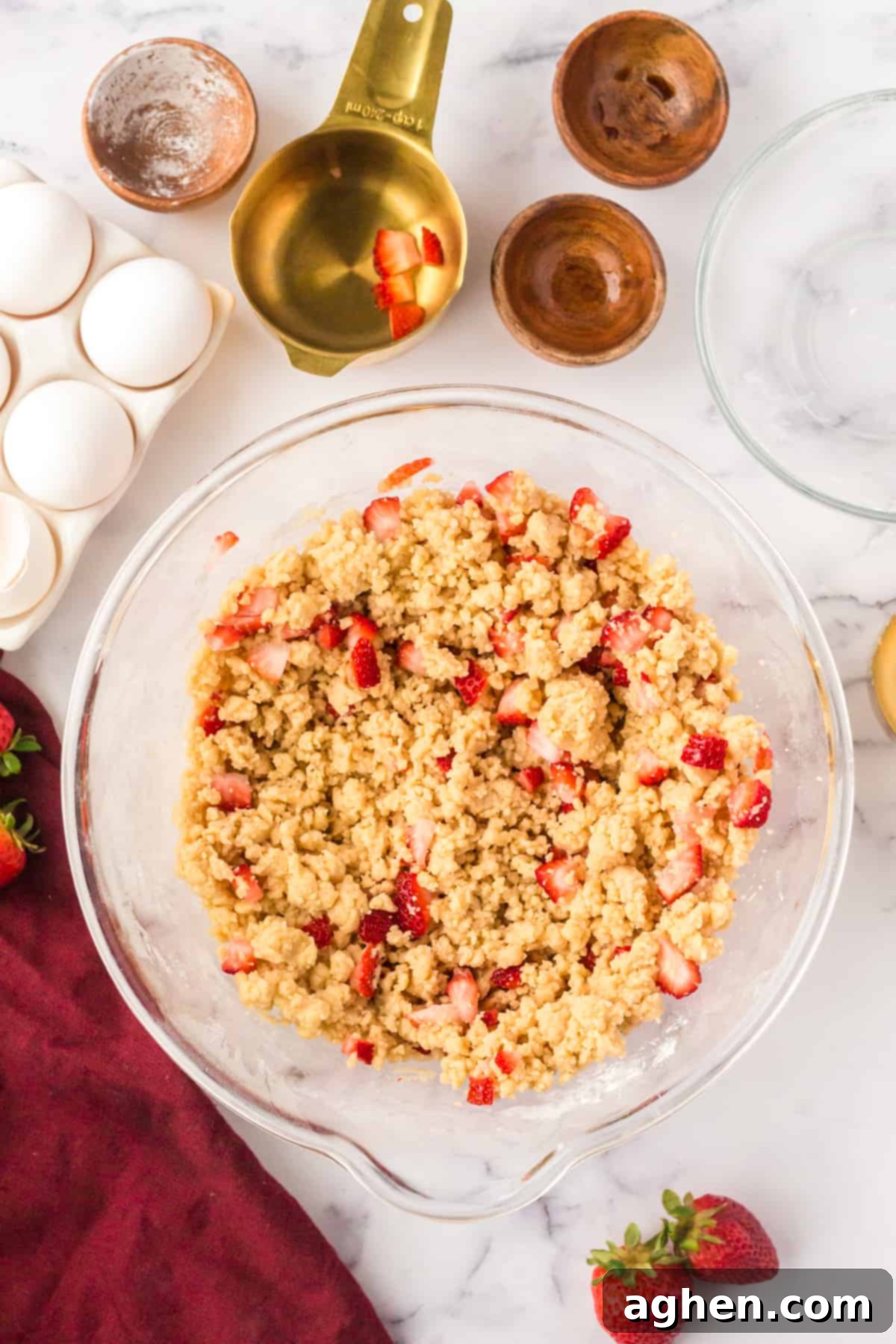 Close-up of a bowl of cookie dough with vibrant fresh strawberry pieces gently folded in, creating a beautiful mix of colors and textures.