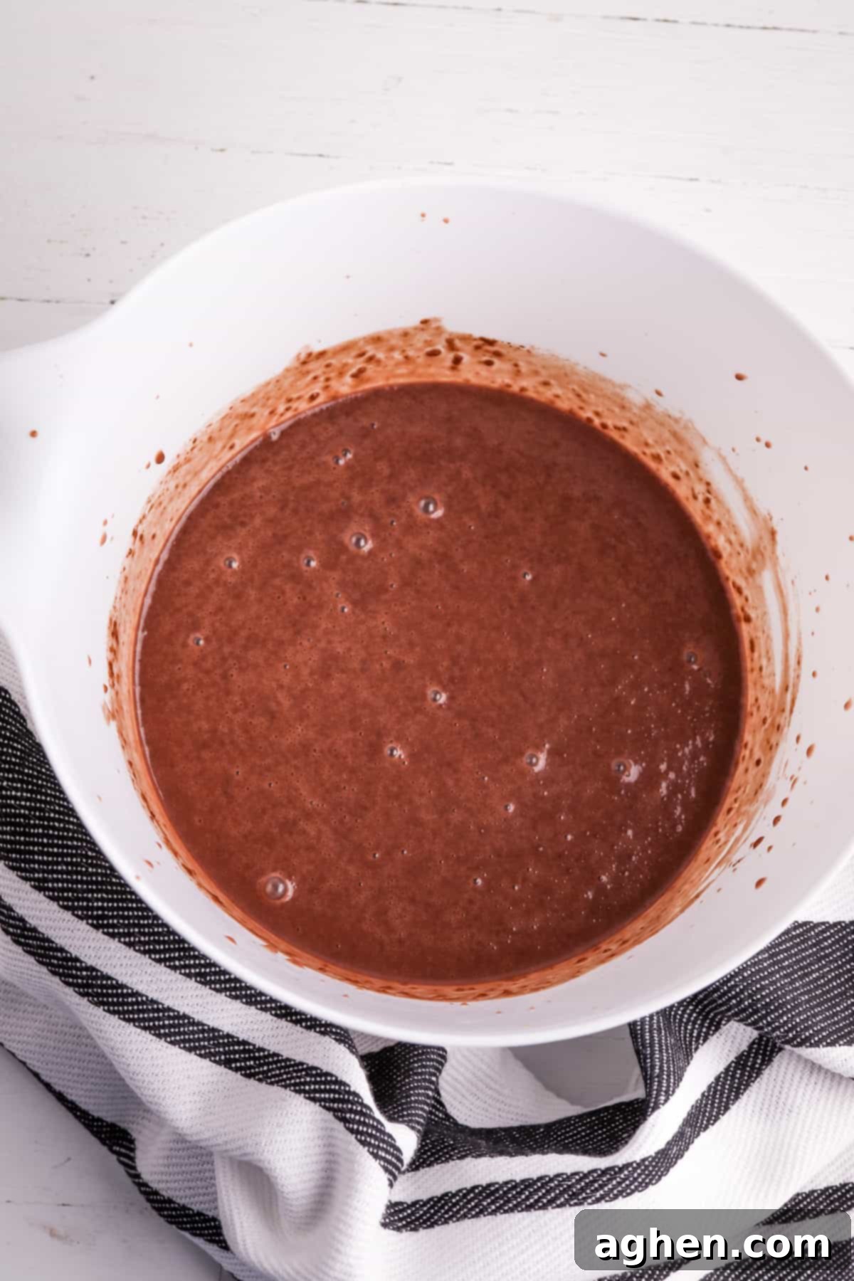 Decadent Chocolate Pie Dip 3 Chocolate pudding being whisked in a large mixing bowl with milk, creating a smooth base for the dip.