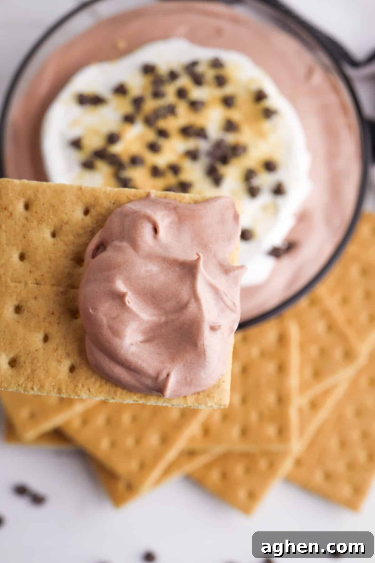 Decadent Chocolate Pie Dip 6 A graham cracker generously dipped into creamy Chocolate Pudding Dip, highlighting the rich texture.