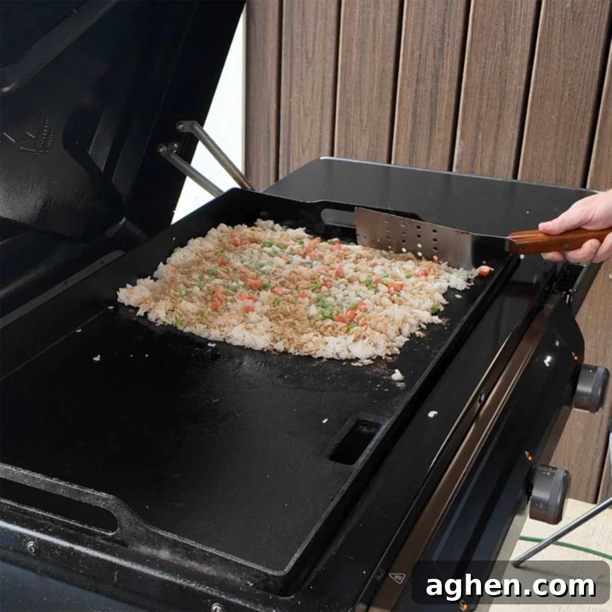 Rice, vegetables, and butter sizzling on the Traeger Flatrock griddle, being stir-fried.