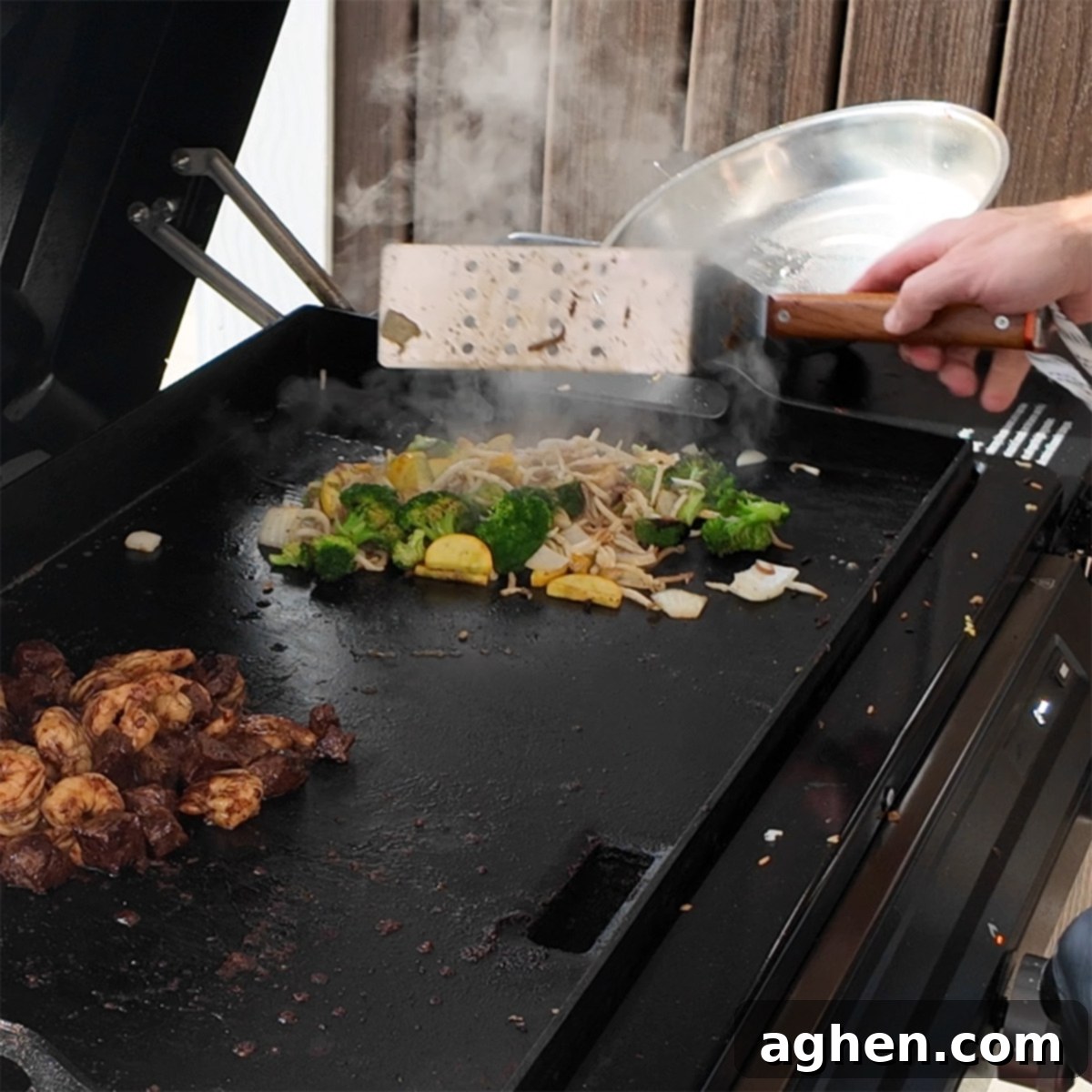 Broccoli, squash, and bean sprouts sautéing on the griddle with oyster sauce.