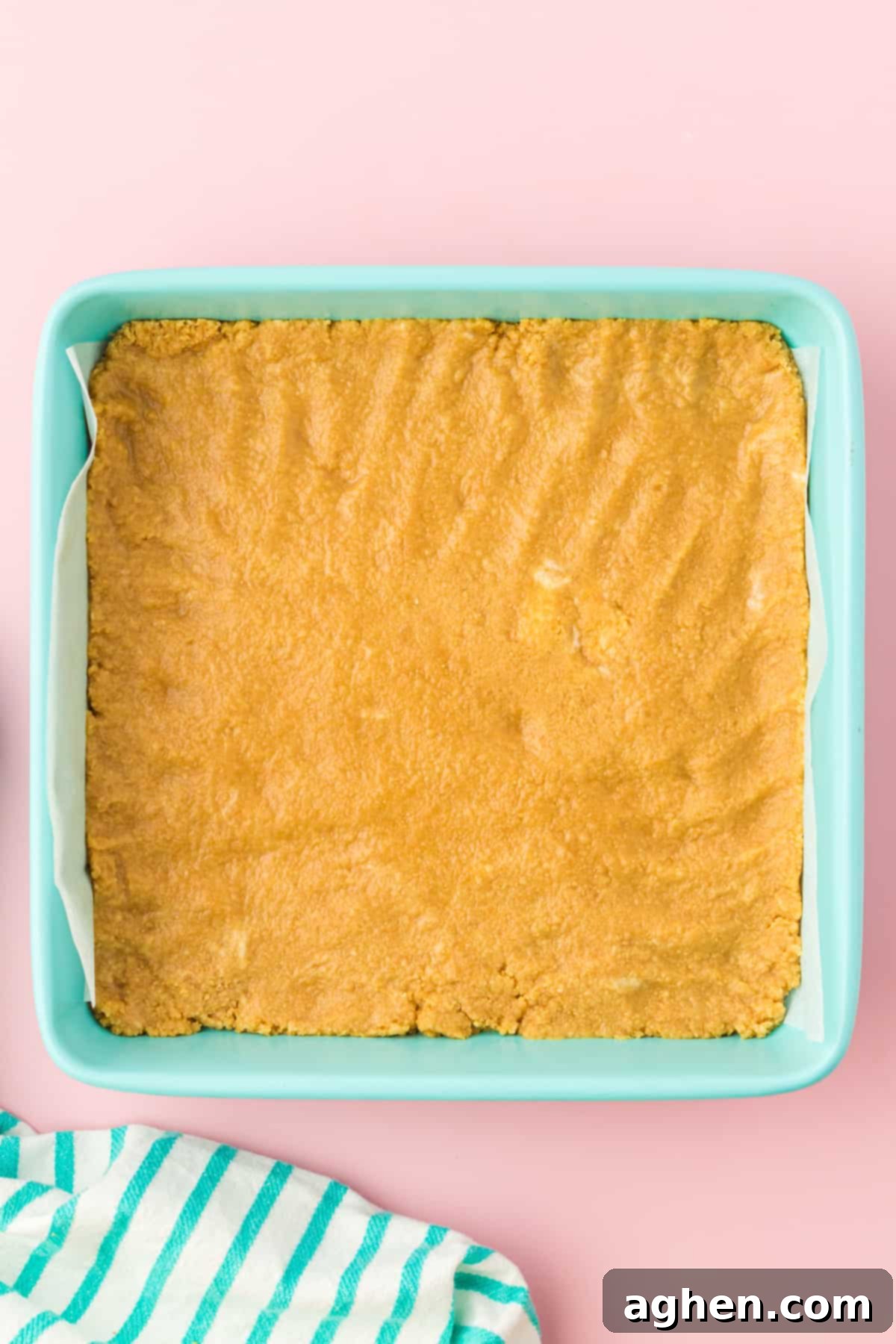 Magical Easter Cookie Bars 5 Golden oreo cookie crust pressed into light blue square baking pan.