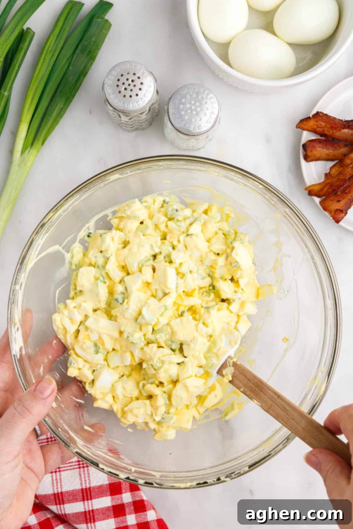Homemade egg salad in glass mixing bowl.