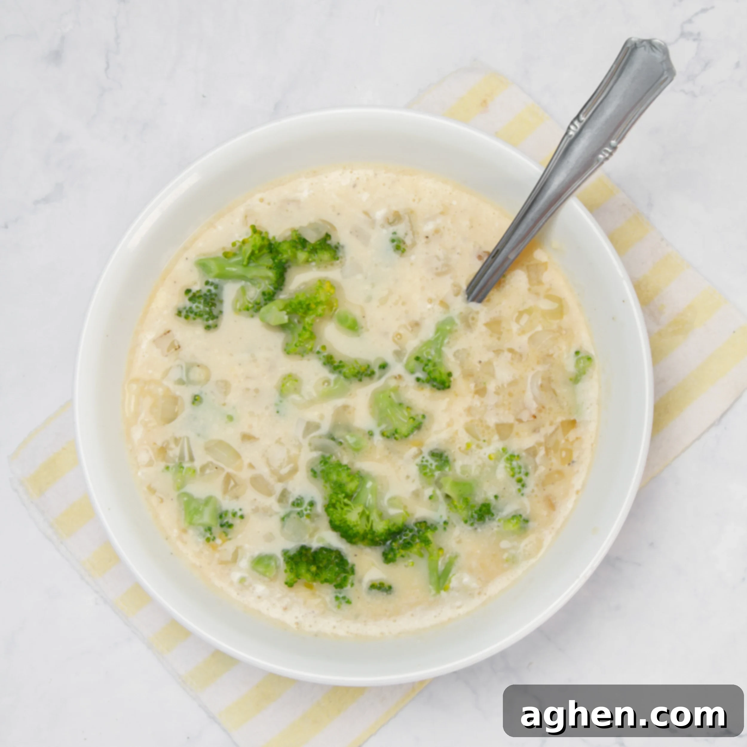 Cheesy Broccoli Breakfast Casserole 6 Broccoli, onion, milk, and cheese added to the whisked egg in the bowl.
