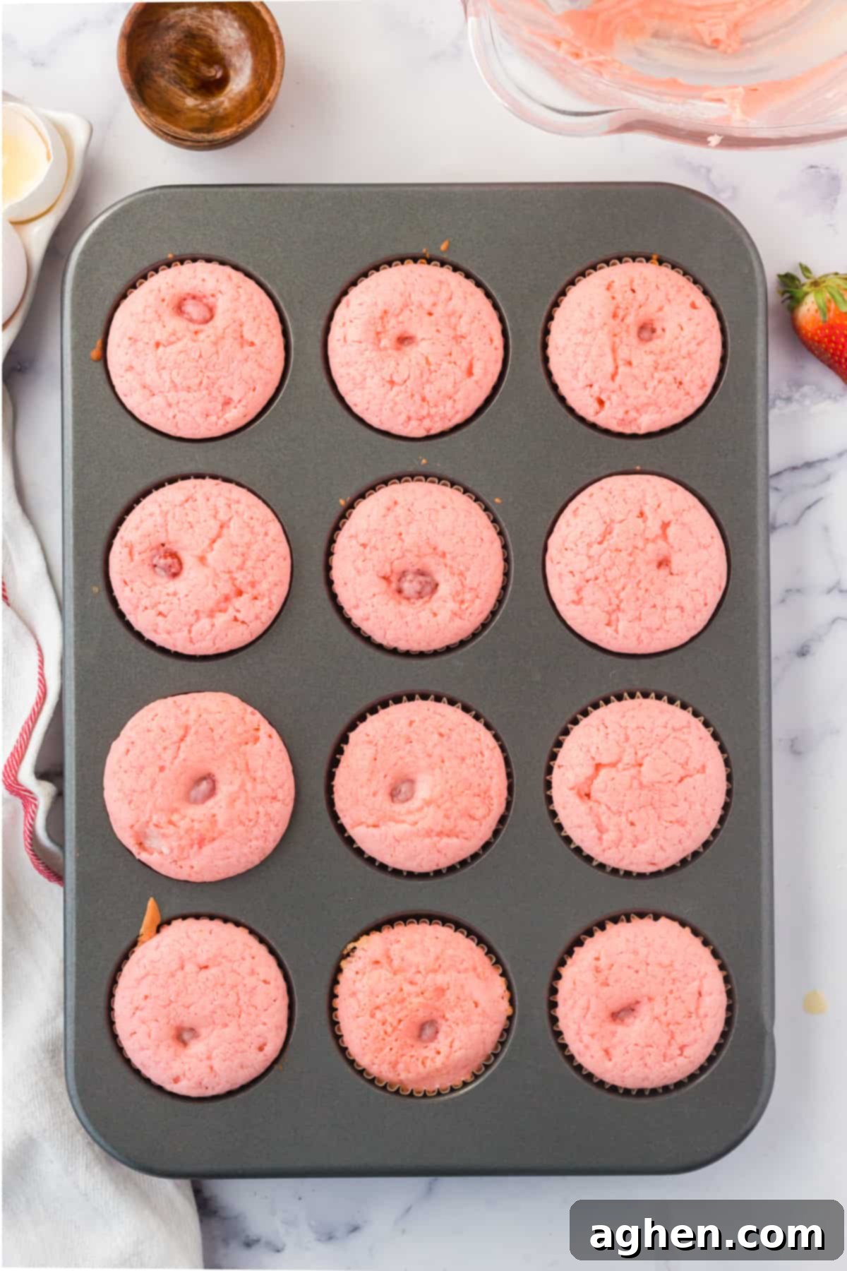 Freshly baked strawberry cupcakes in muffin tin