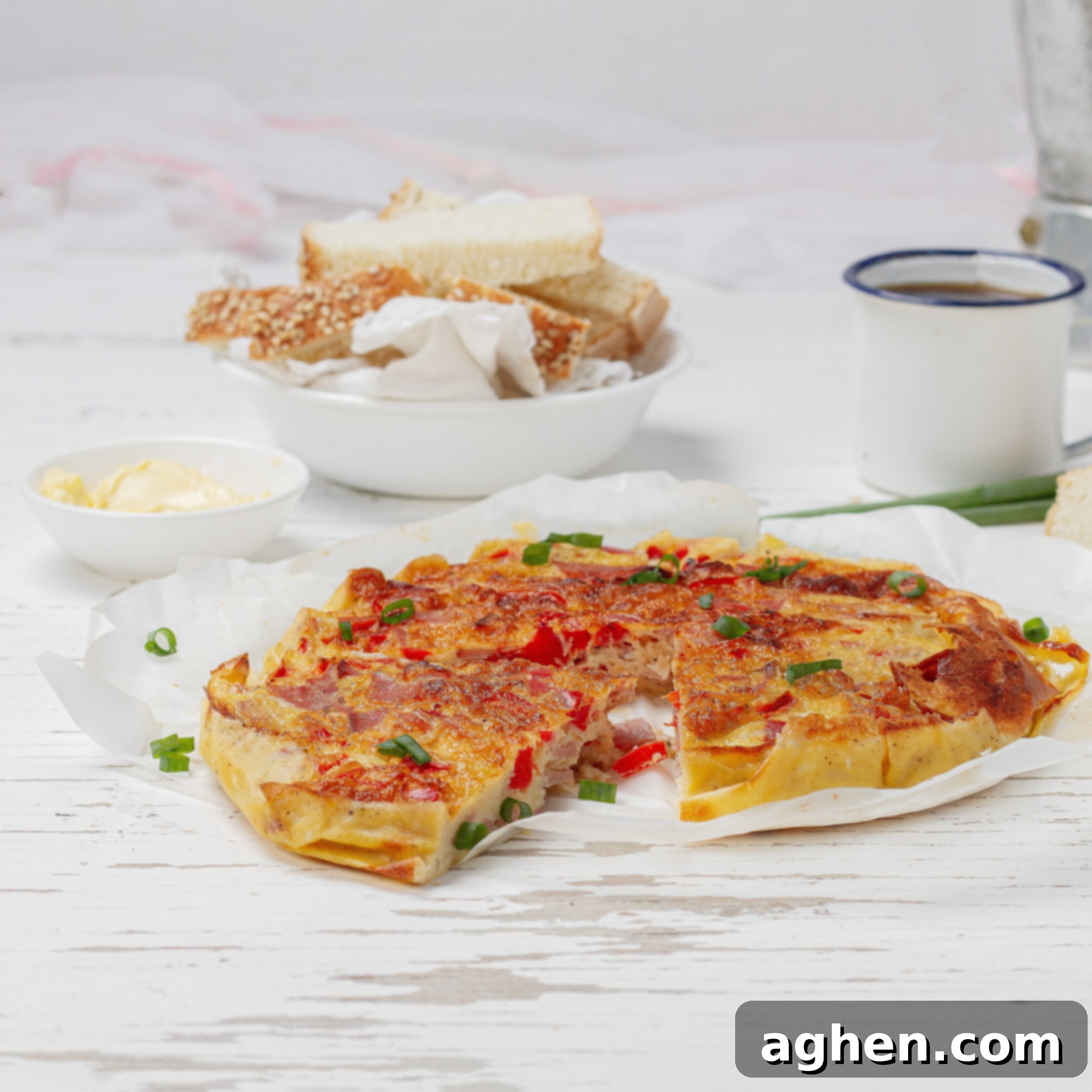 A fluffy, golden Air Fryer Frittata on a white plate, garnished and ready to serve.