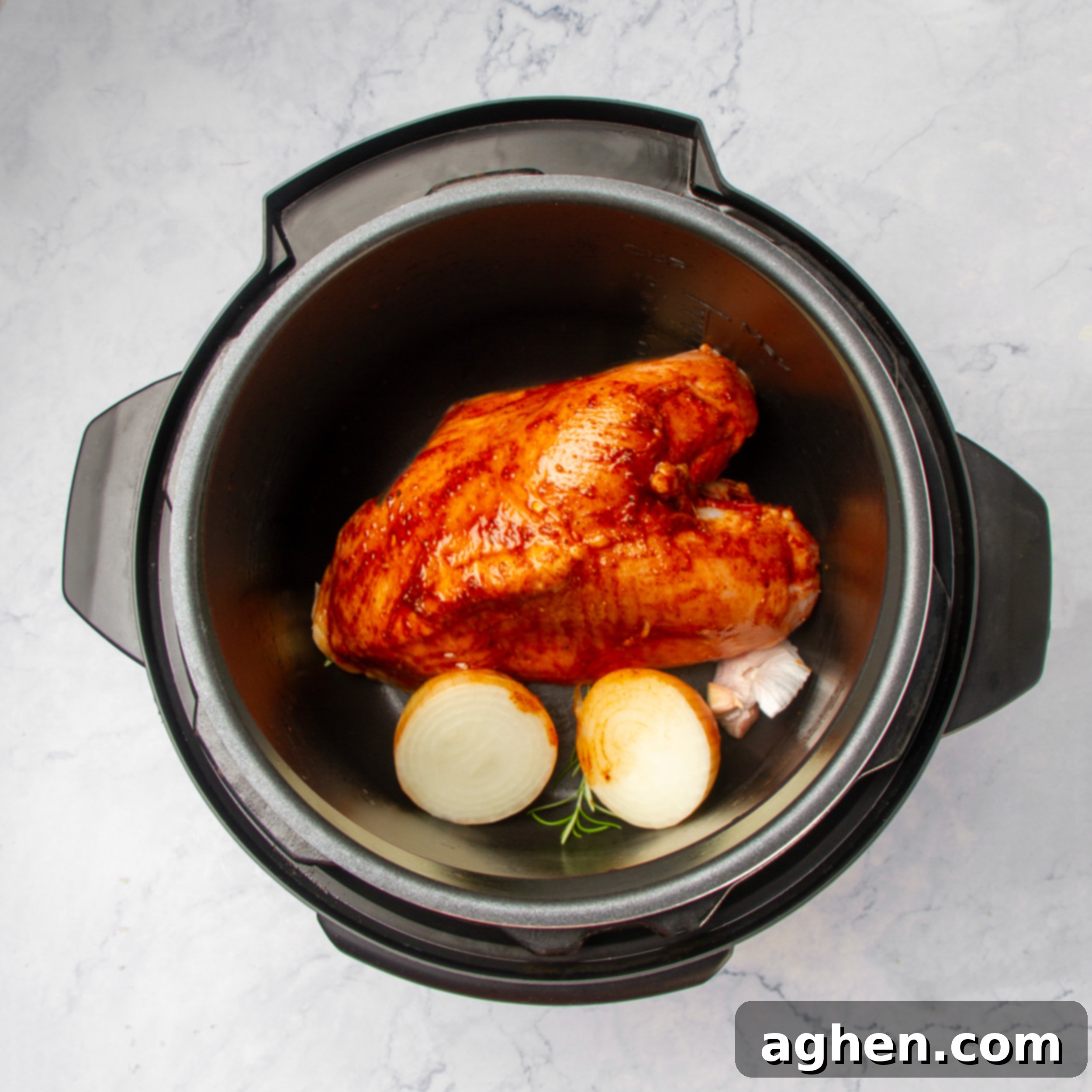 Effortless & Juicy Slow Cooker Turkey Breast 6 Marinated uncooked turkey breast and aromatics in a slow cooker pot.
