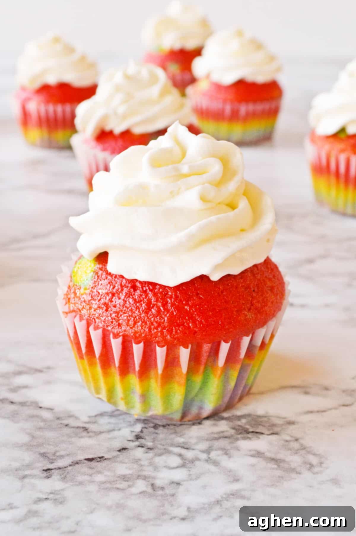 Rainbow cupcake from cake mix topped with vanilla frosting.