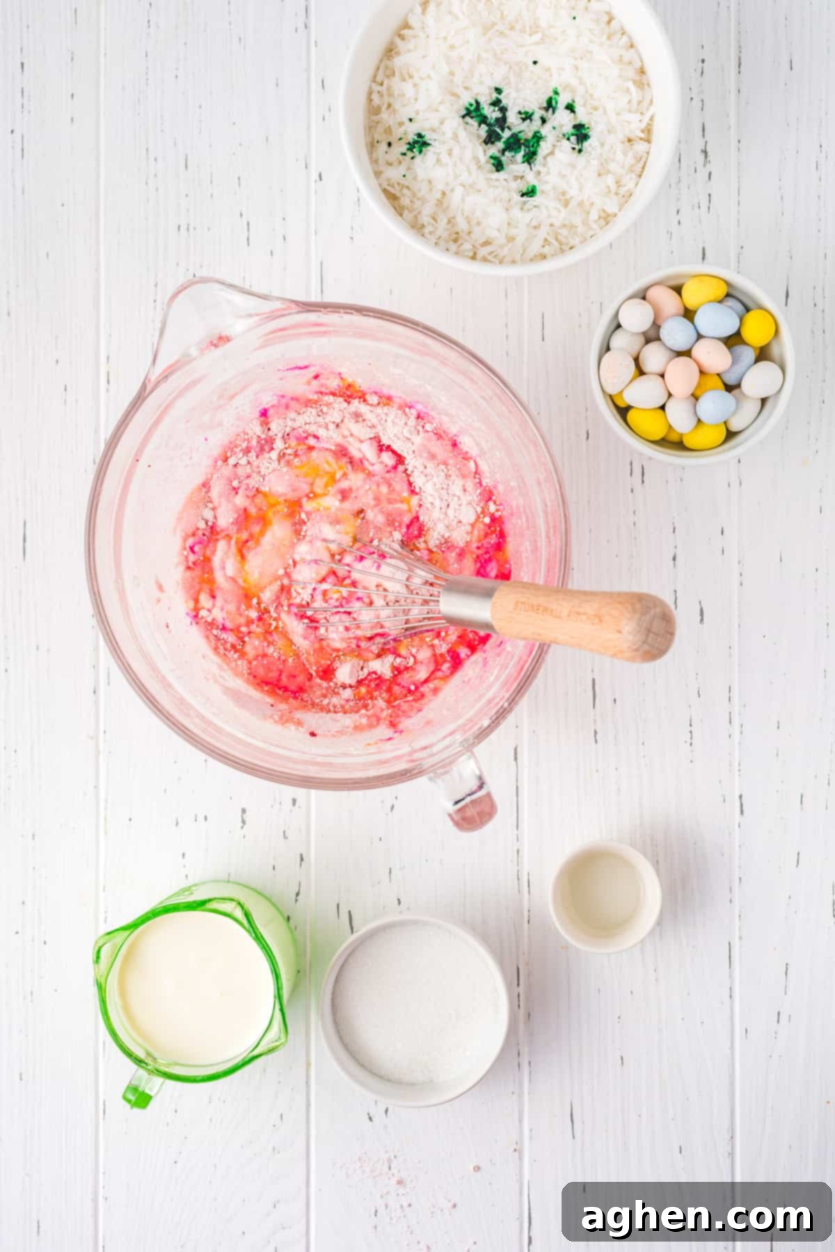 Mixing strawberry cake batter in large glass mixing bowl.