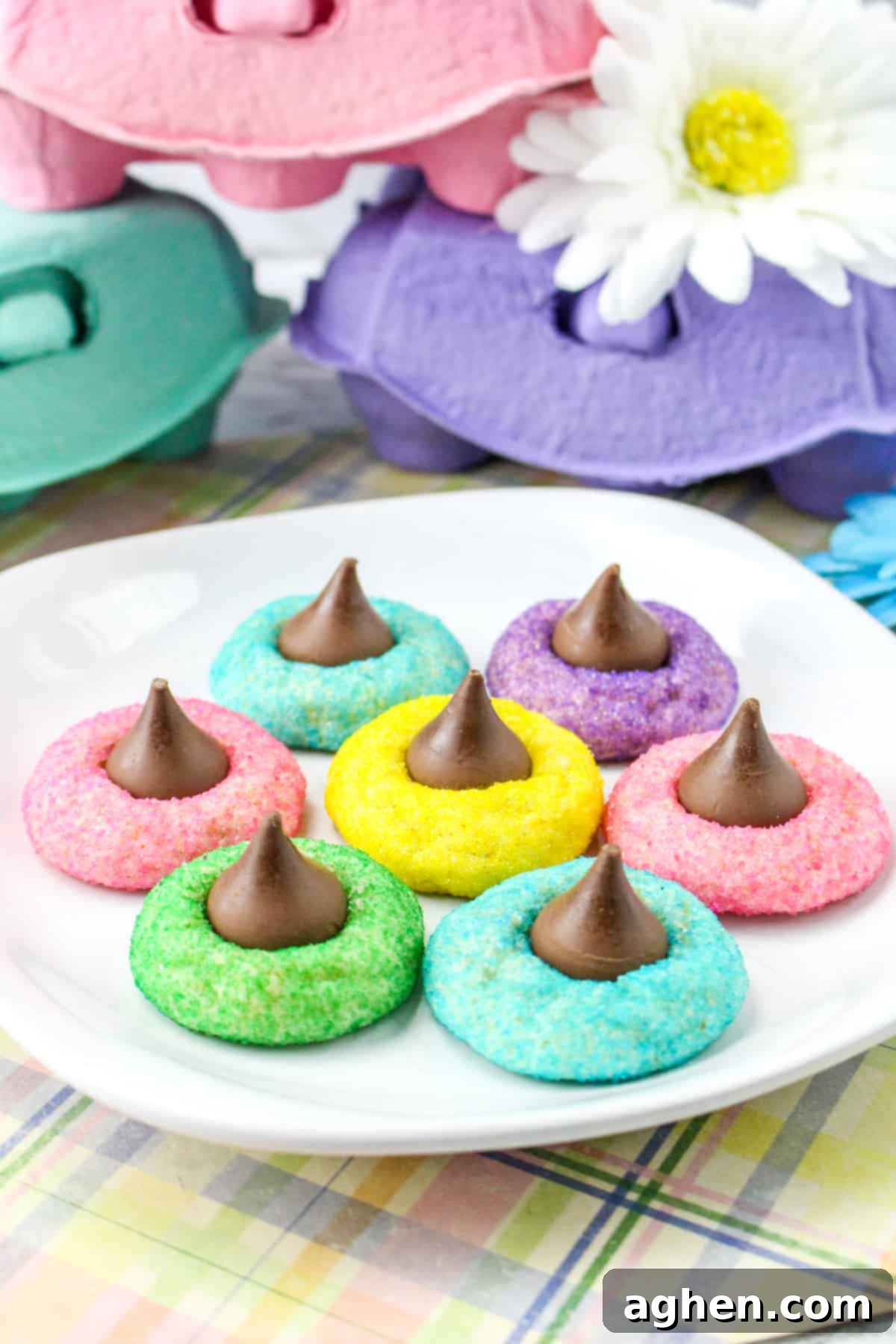 Colorful Easter Blossom Cookies with Hershey Kisses on a white plate, showcasing pastel hues.