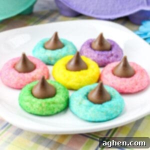 Colorful Easter Blossom Cookies with Hershey Kisses on white plate.