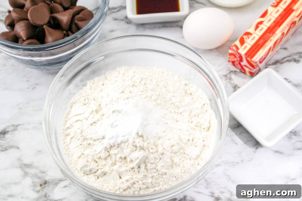 Dry ingredients combined in a glass mixing bowl, ready for the next step.