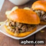 Slow cooker Philly Cheesesteak Sloppy Joes on buns with potato chips.