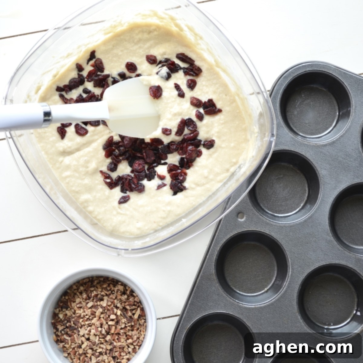 Guilt-Free Cranberry Pecan Muffins 4 Mixing muffin batter with cranberries for a low-point recipe
