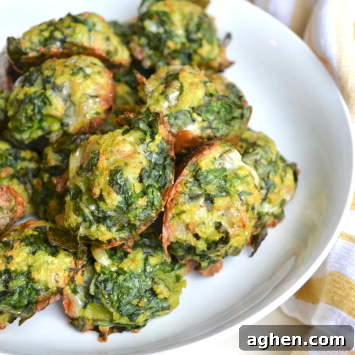 Delicious Weight Watchers spinach balls served as an appetizer on a plate with dipping sauce