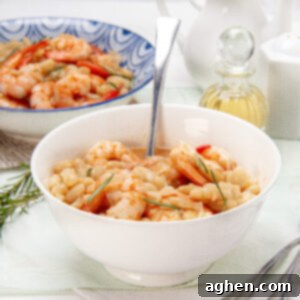 Creamy and satisfying Lemony shrimp and bean stew in a bowl with a spoon.