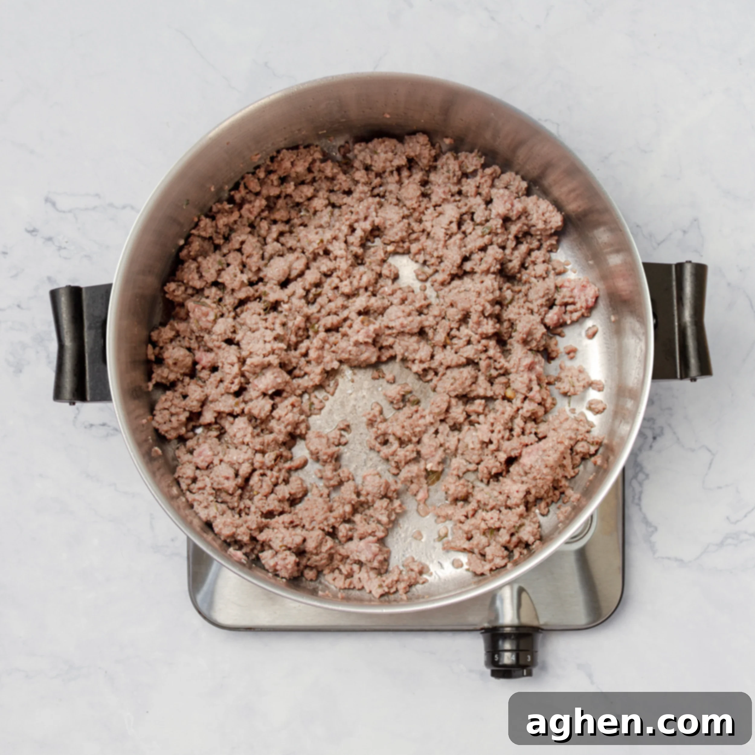 Ground turkey browning in a large pot on the stovetop.