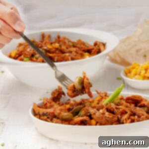 Brunswick Stew: Delicious and Weight Watchers Approved 7 Meaty Brunswick stew in a dish with a fork.