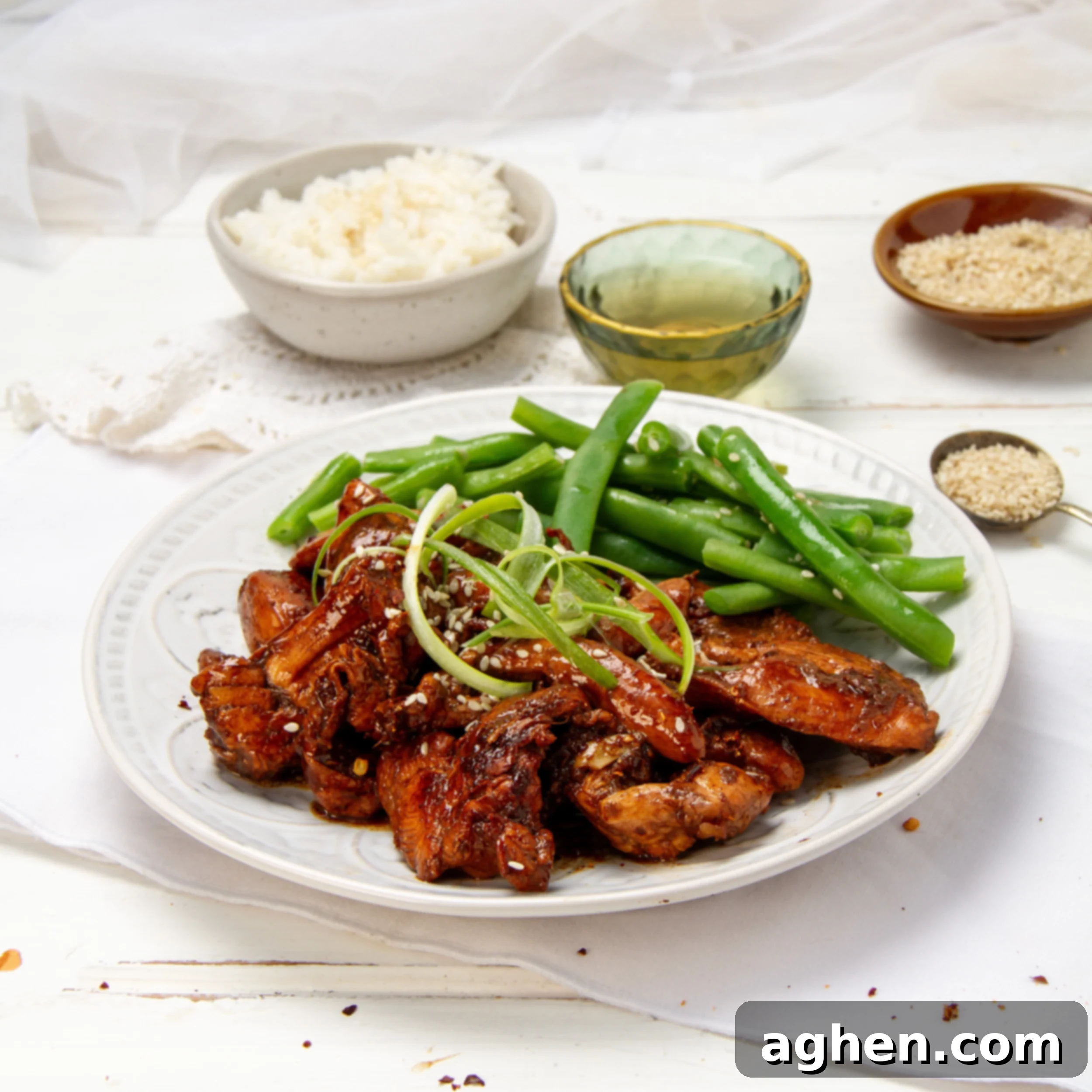 Korean Chicken Bulgogi served on a plate with fresh green beans, garnished with sesame seeds.